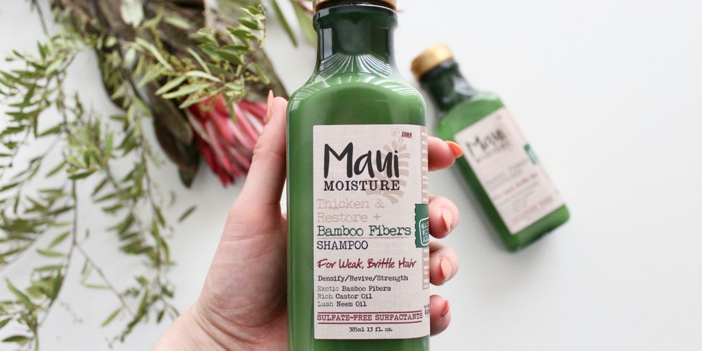 person h olding Maui moisture bottle
